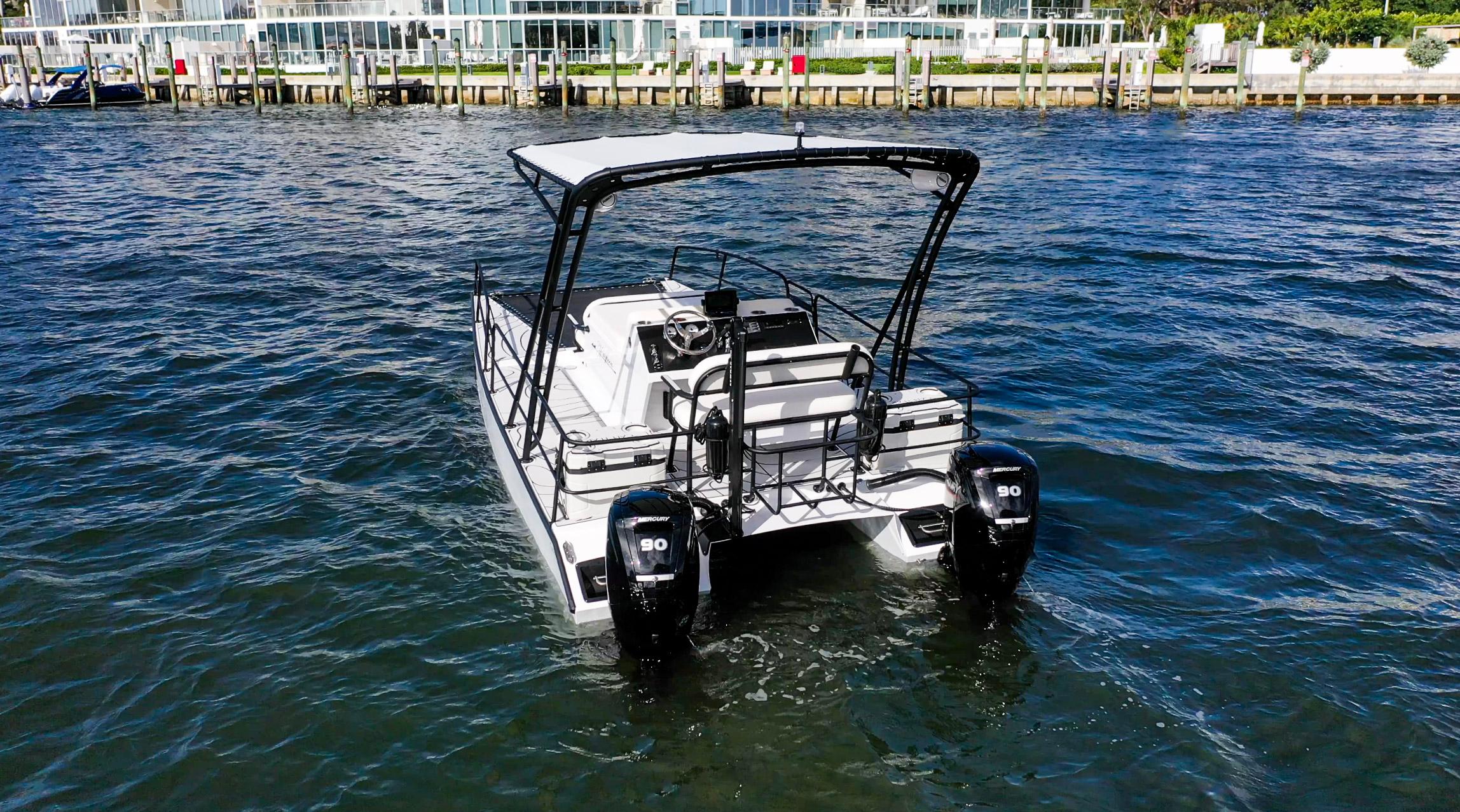 2025 Pontoon Harpoon boat with dual engines on a sunny waterfront.