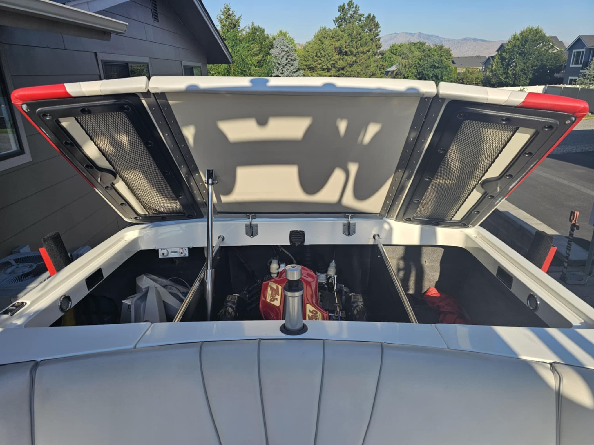 Open engine compartment of a 2006 MB PIGPR boat outdoors.