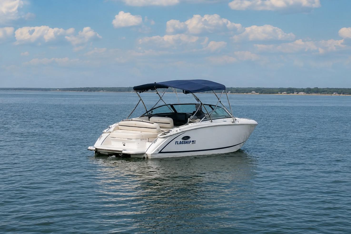 2019 Cobalt R3 boat with canopy on calm water under blue sky.
