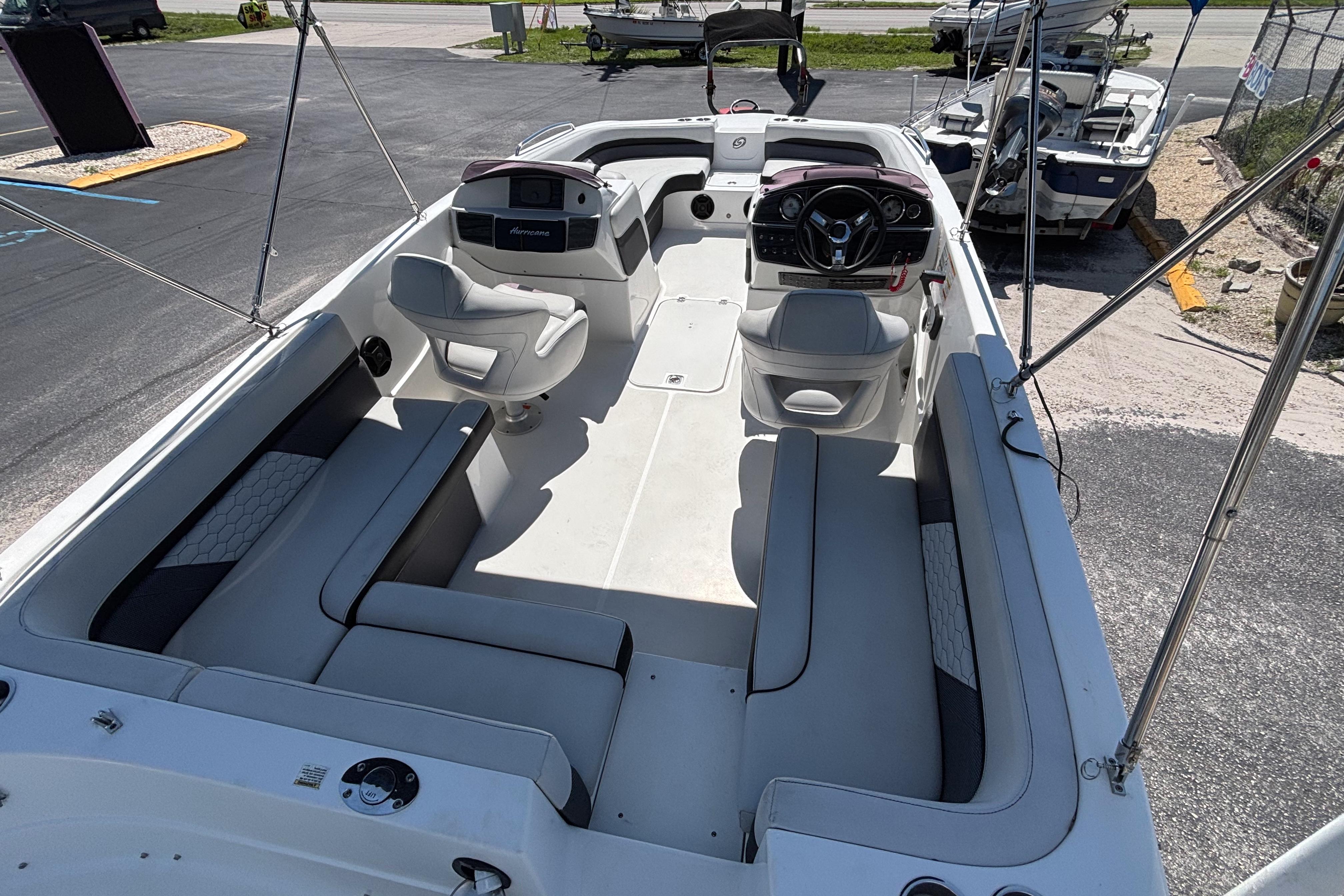 2019 Hurricane Sundeck Sport 218 OB boat interior with seating and steering console.
