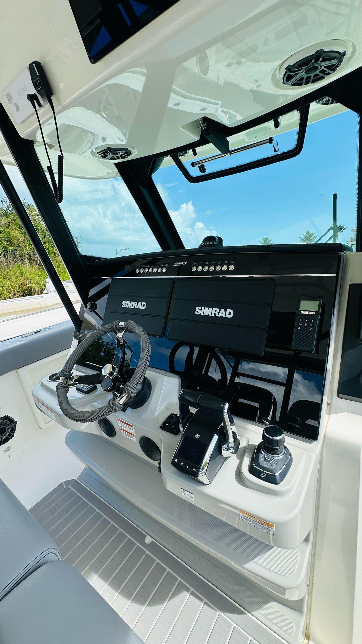 2023 Boston Whaler 360 Outrage helm with Simrad electronics and modern controls.