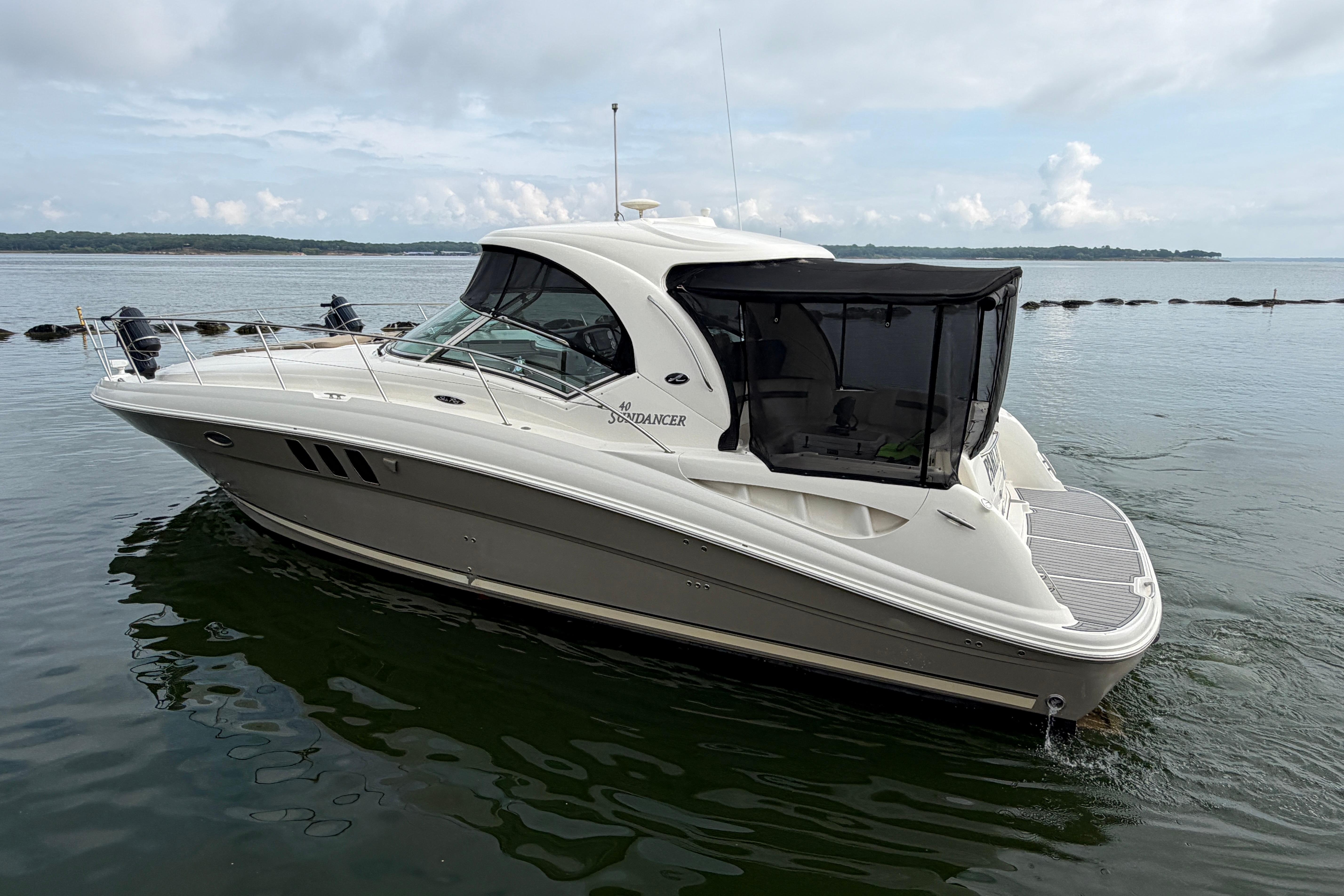 2006 Sea Ray 40 Sundancer yacht on calm water, featuring sleek design and spacious deck.