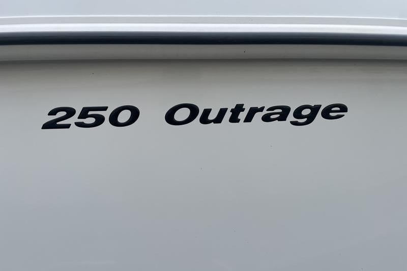 2012 Boston Whaler 250 Outrage boat nameplate on white hull.
