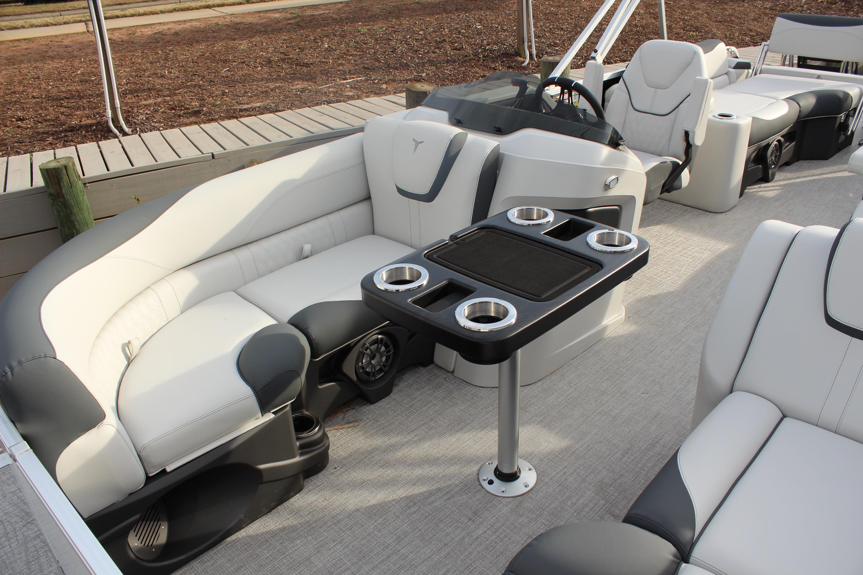 2026 Tahoe Pontoon LTZ interior with plush seating and cup holders on a sleek deck.