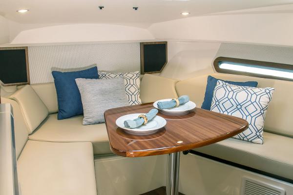 Manufacturer Provided Image: 2021 Pursuit OS 325 Offshore cabin with dining table and cushioned seating.
