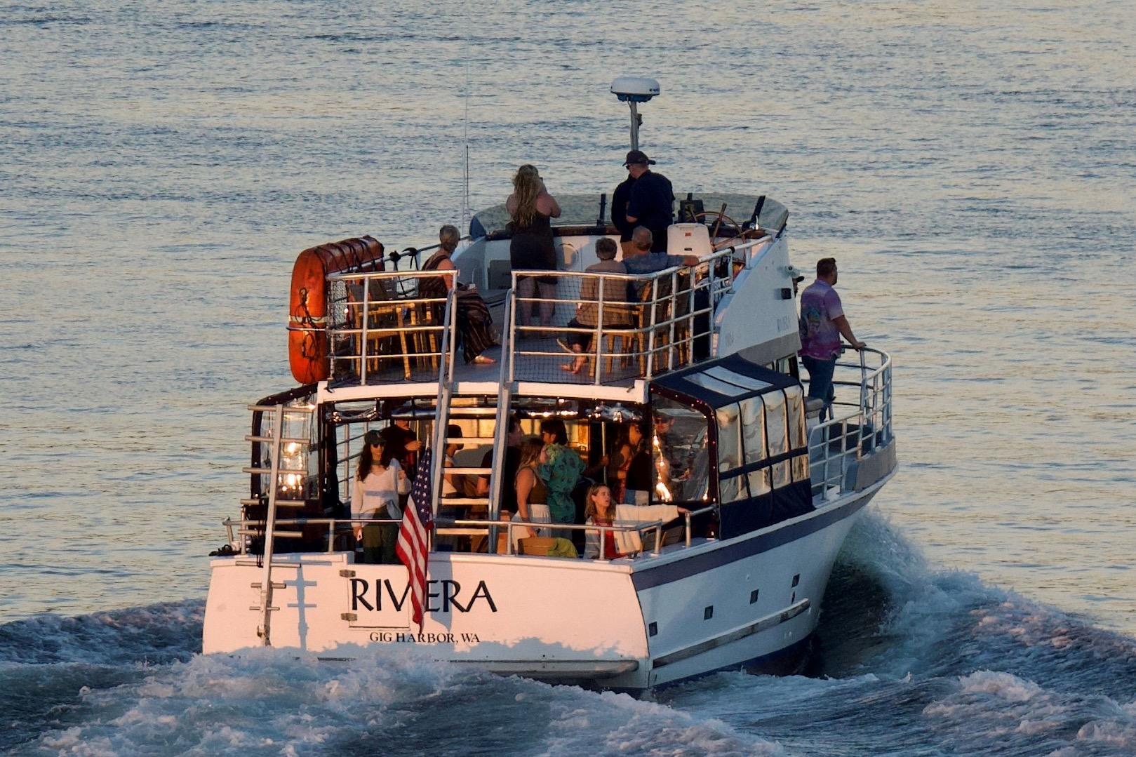 1964 Grandy Tour Boat "Rivera" cruising with passengers on calm waters.