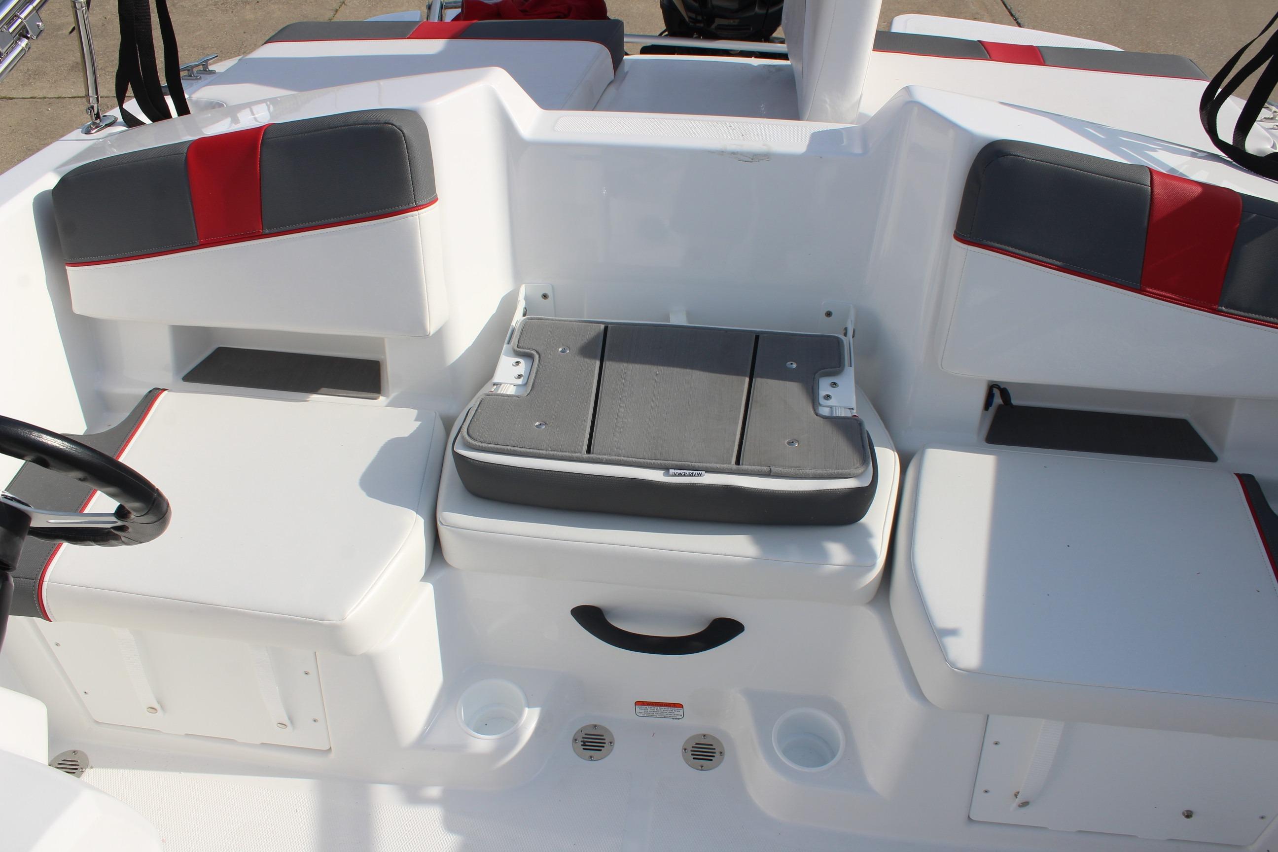 2026 Tahoe T18 boat interior with white and red seating, featuring a foldable table.