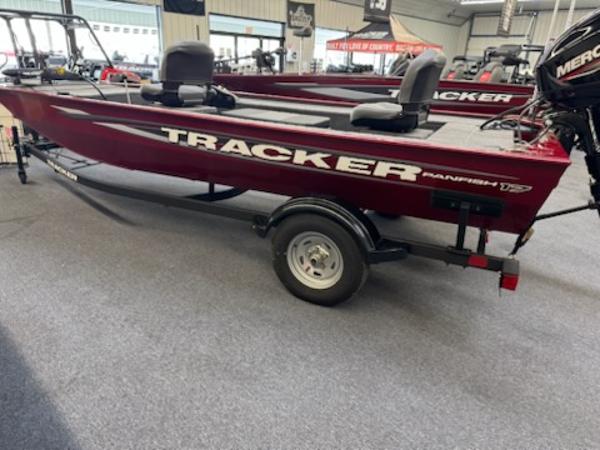 2025 Tracker Panfish 17 boat in showroom, red exterior, on trailer.