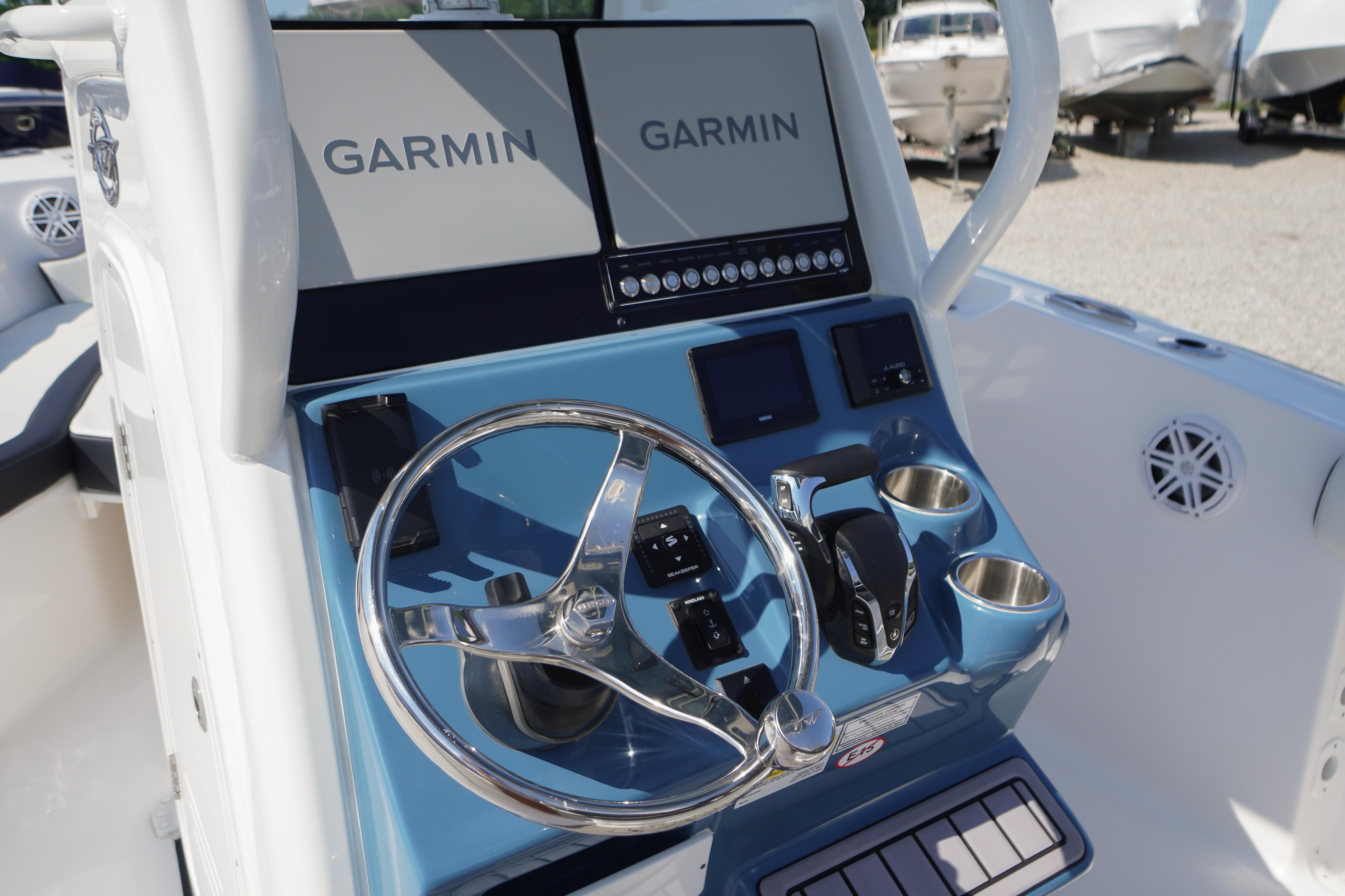 2025 Tidewater 232 SS boat dashboard with Garmin displays and steering wheel.