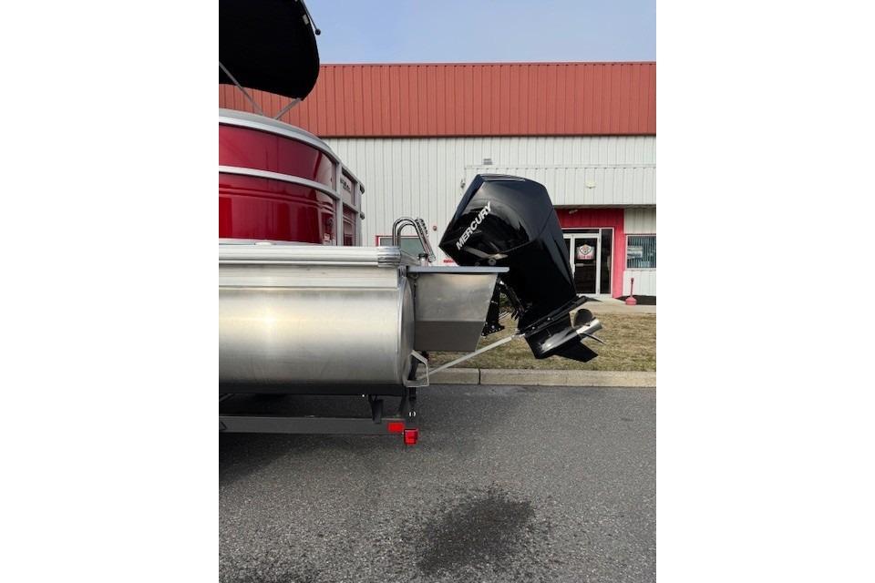 2026 Sun Tracker Party Barge 24 XP3 with Mercury outboard motor, parked outdoors.