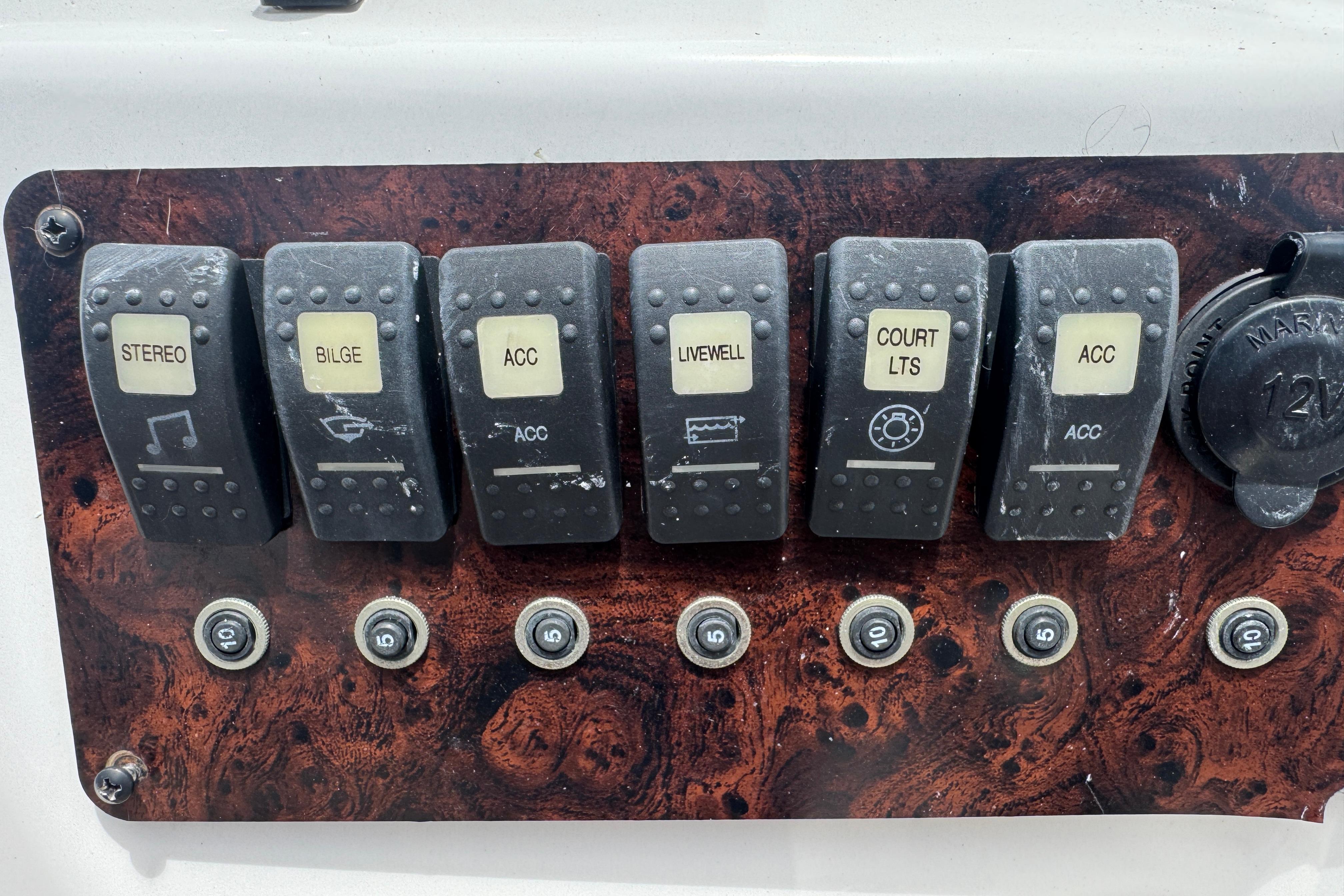Control panel of a 2013 Hurricane SunDeck Sport 188 OB boat with labeled switches.