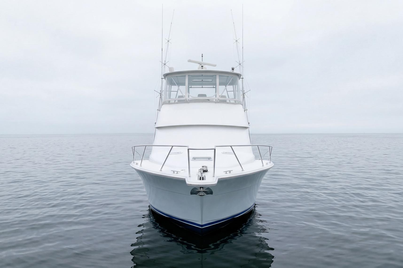 Front view of a 2000 Viking 50' Convertible yacht on calm waters.