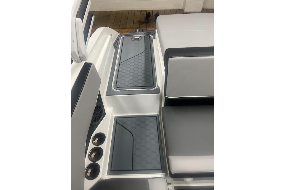 2025 Cobalt CS23 Surf boat interior with sleek seating and hexagonal pattern flooring.
