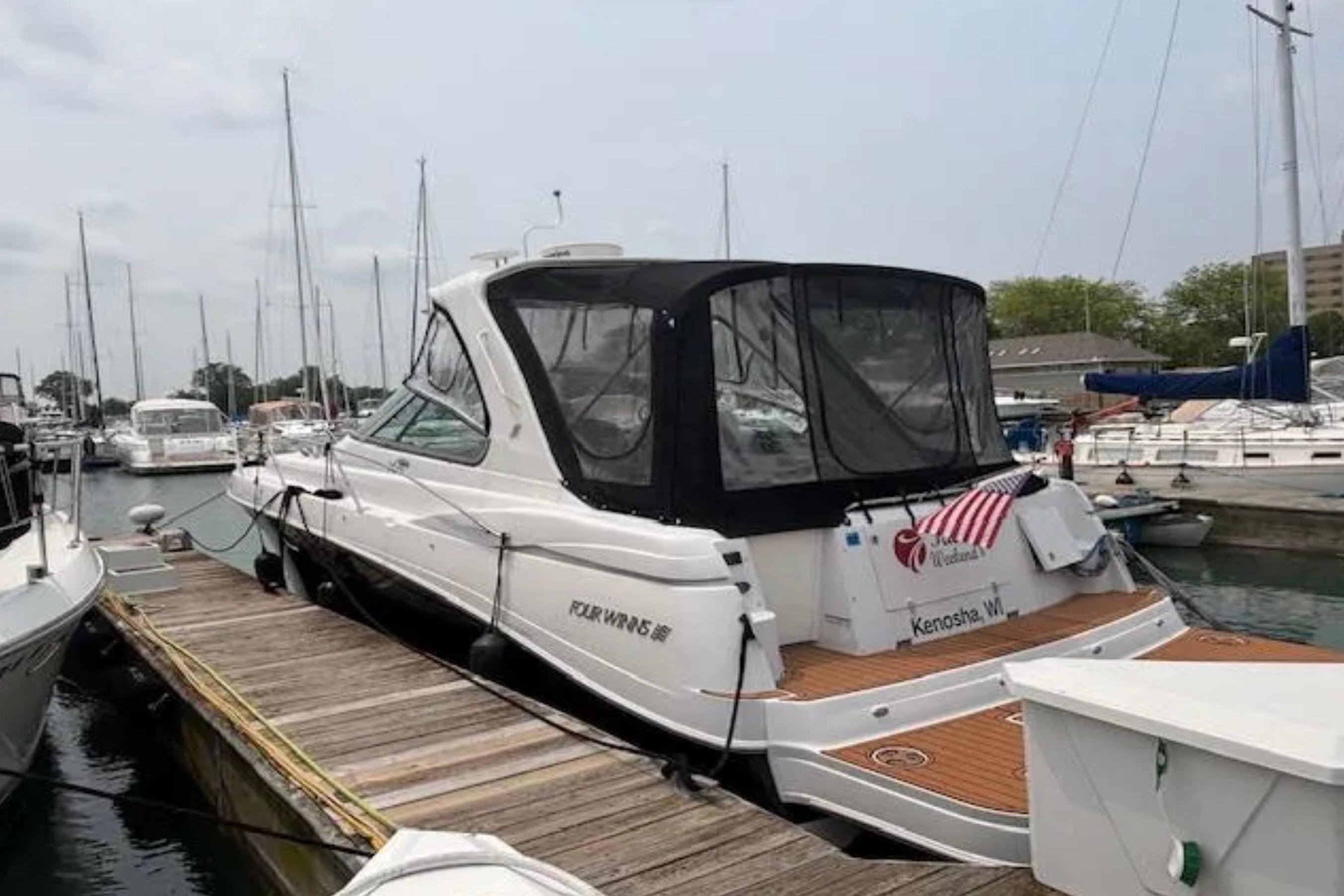 2007 Four Winns 378 Vista yacht docked at marina with American flag.