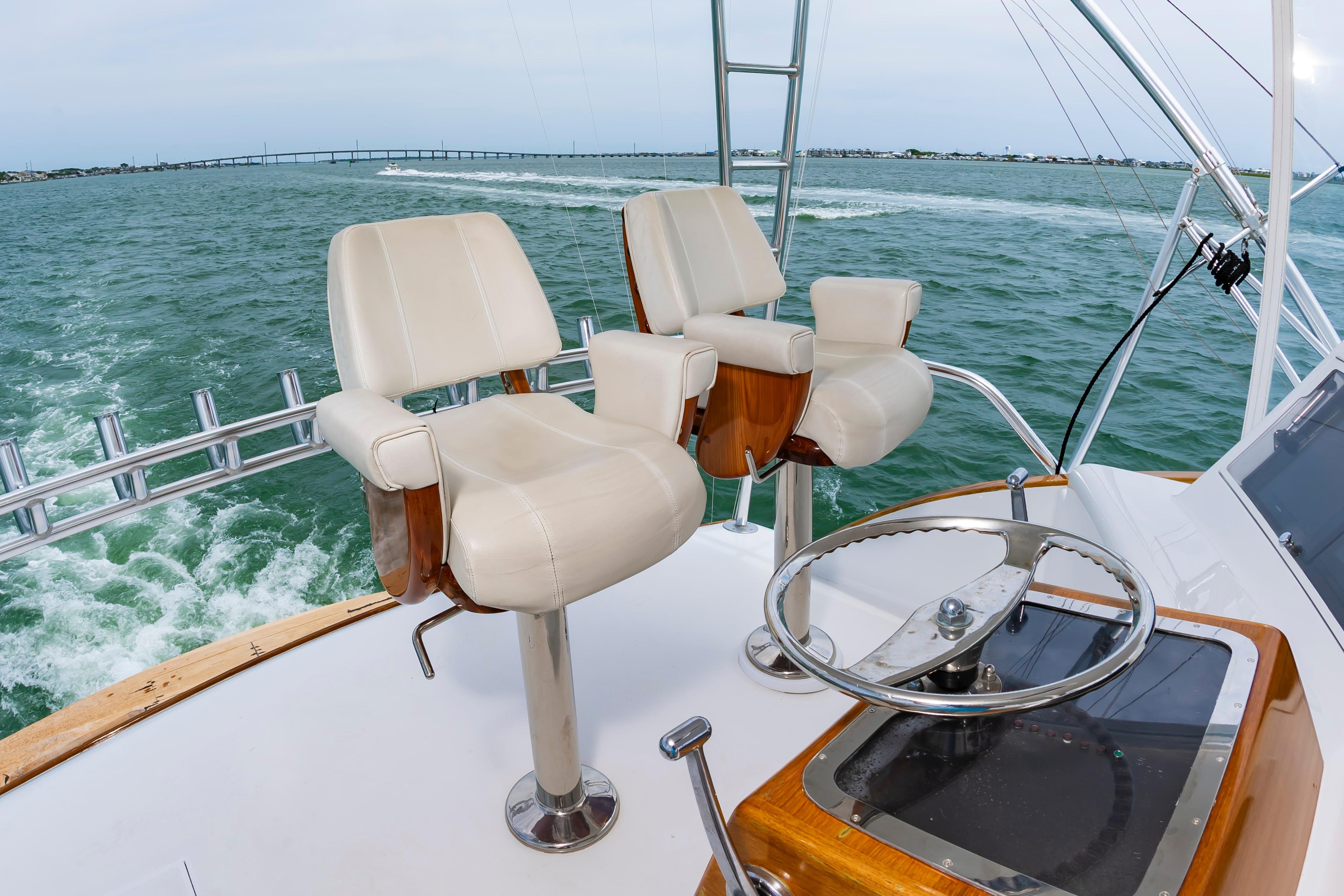 Helm of 1993 Custom Carolina Scarborough 56 Convertible yacht with dual captain chairs.