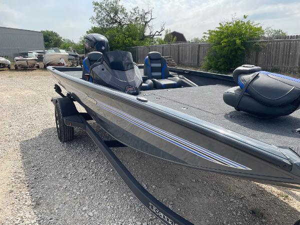 2025 Ranger RT188P fishing boat parked on gravel, featuring sleek design and modern seating.