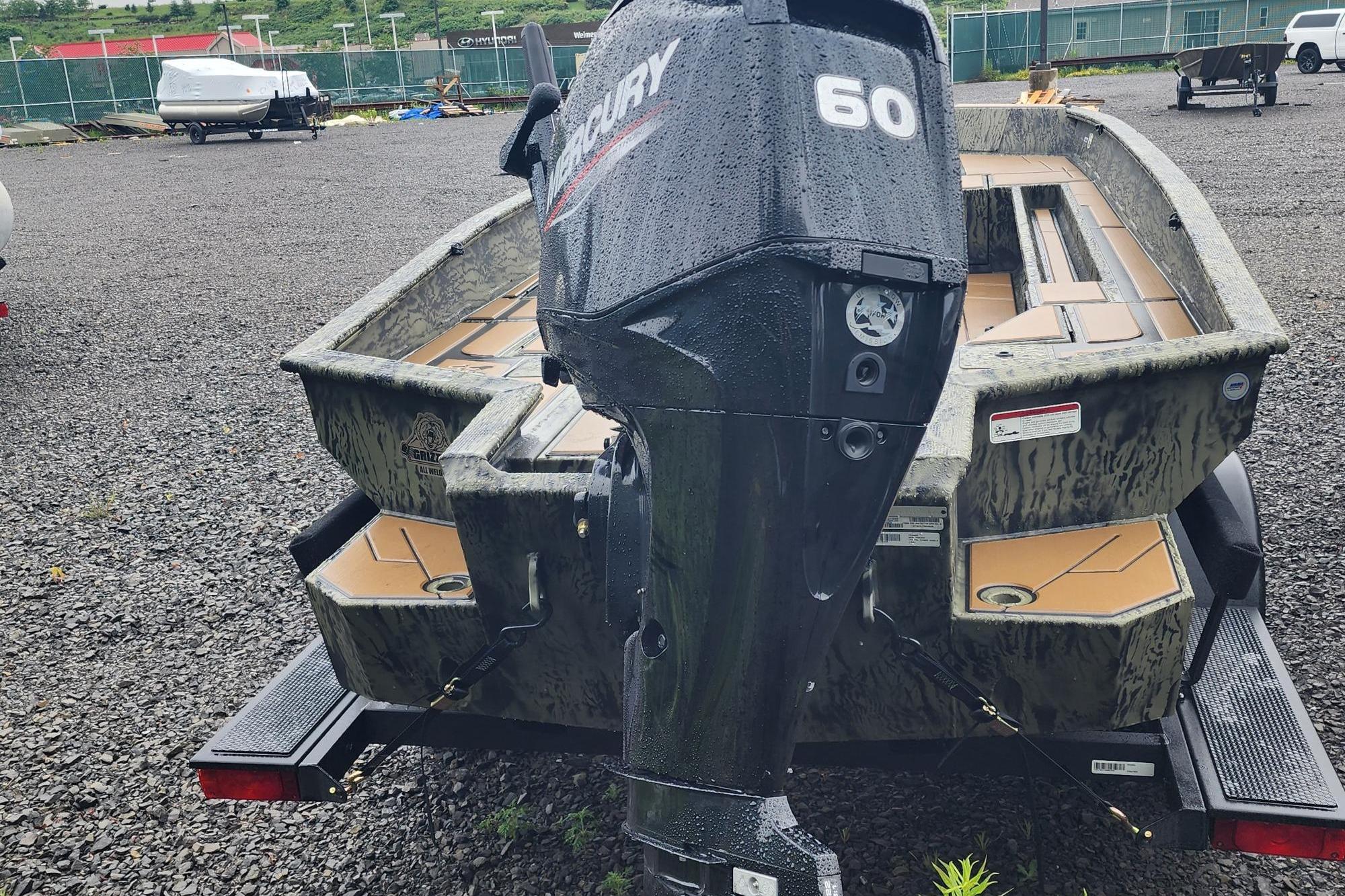 2026 Tracker Grizzly 1756 T Marsh boat with Mercury 60 outboard motor on trailer.