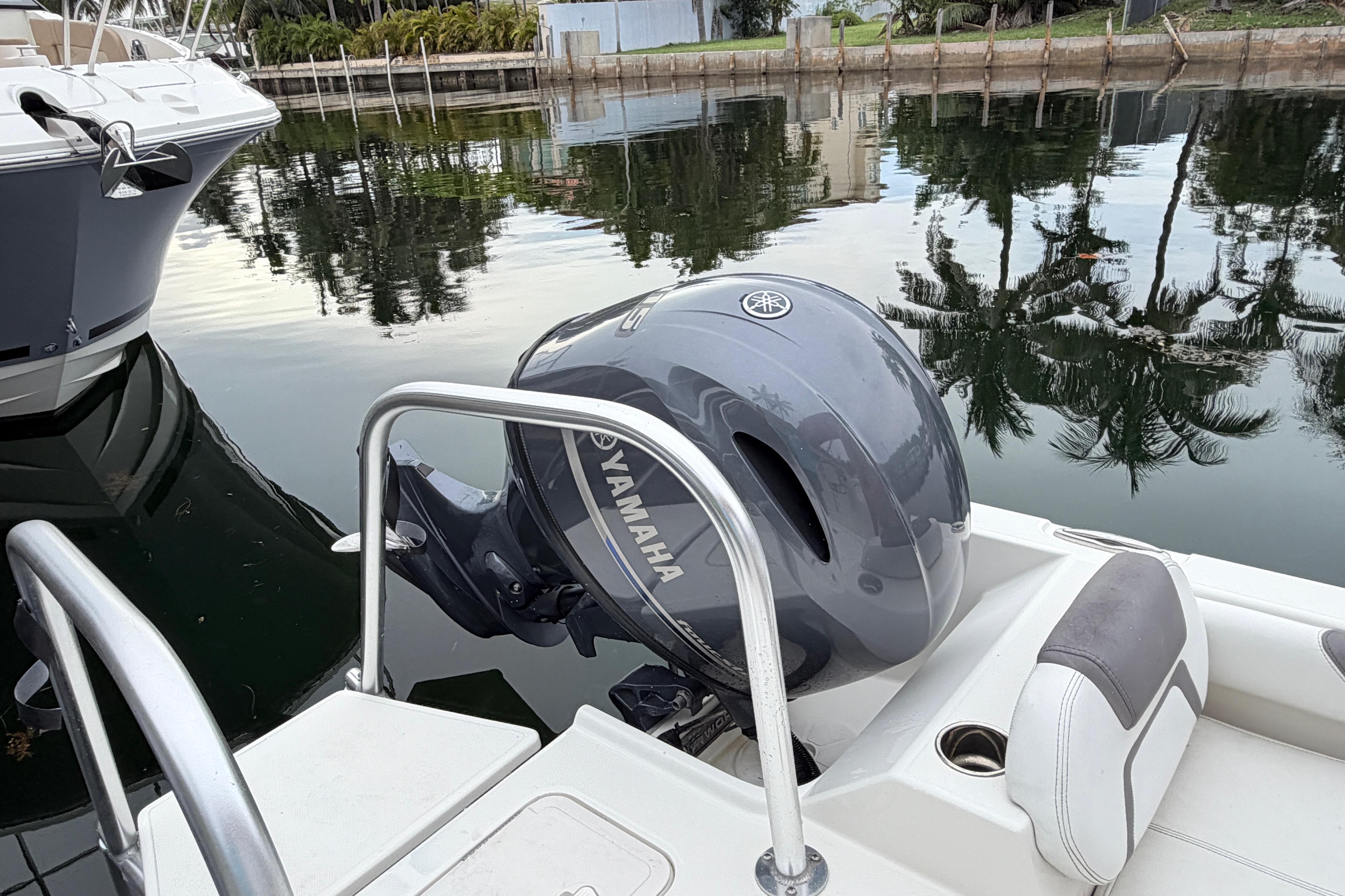 2019 World Cat 230 DC boat with Yamaha outboard motor docked by calm waters.