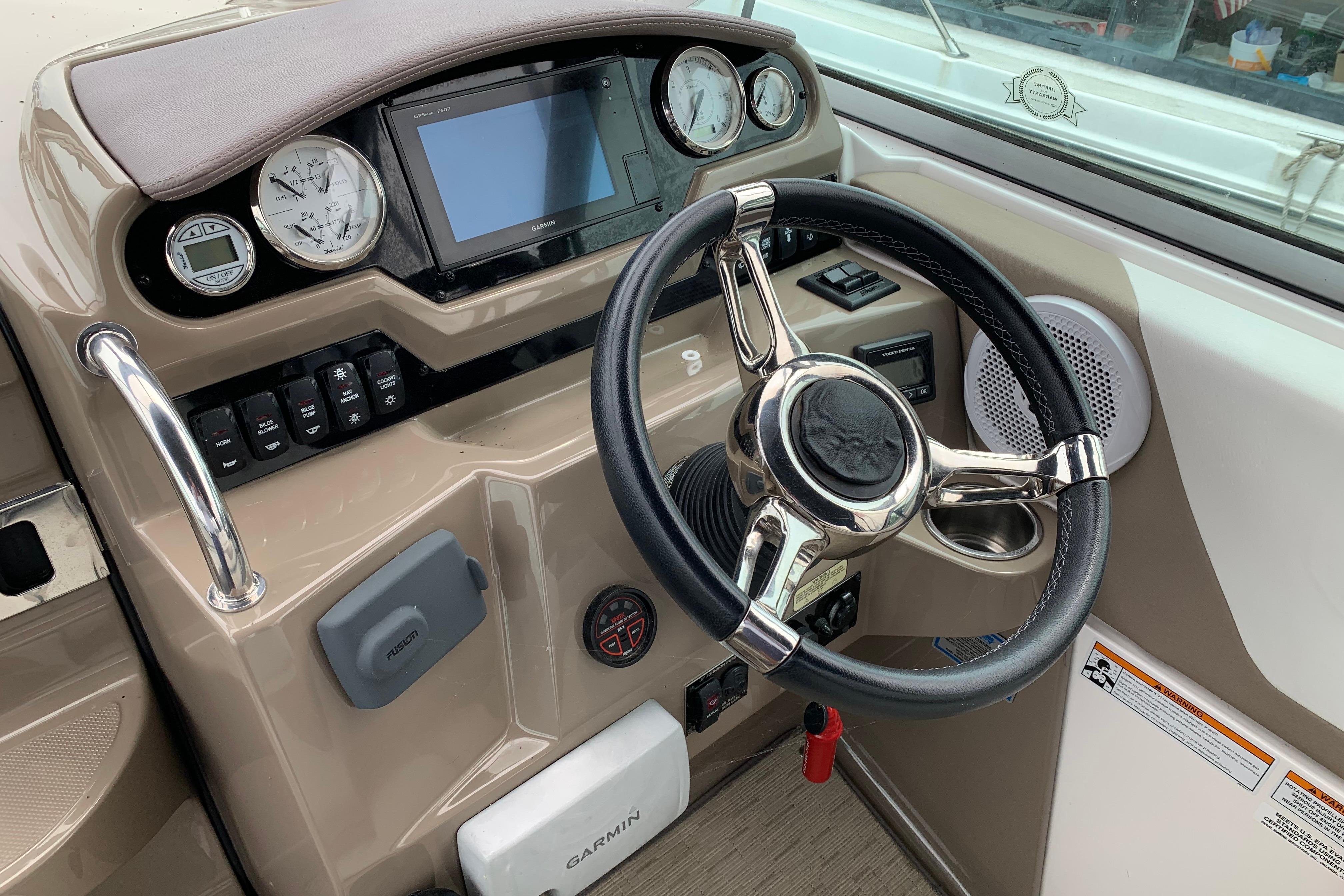 2017 Regal 26 Express boat dashboard with steering wheel and navigation instruments.