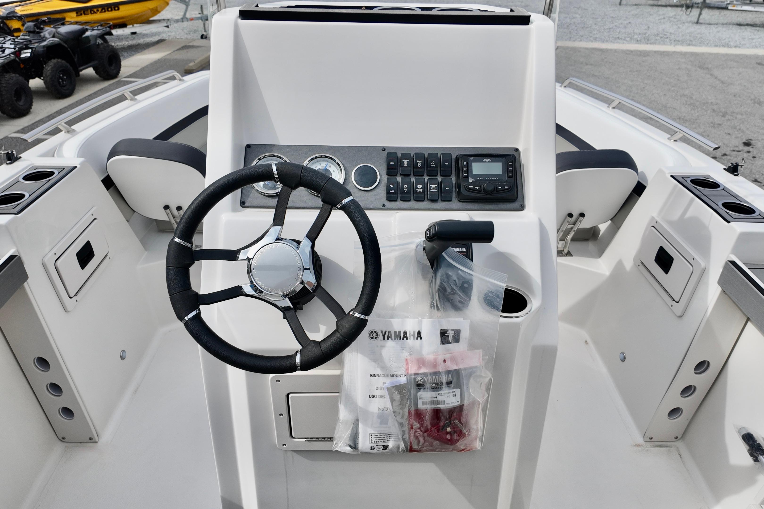 2026 Starcraft SVX 191 OB CC boat console with steering wheel and controls.