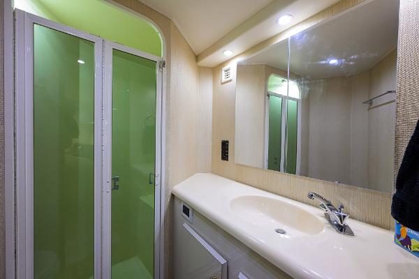 Bathroom interior of 2000 Viking 50 Convertible yacht with shower and vanity.