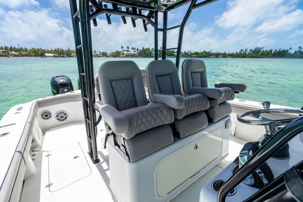 2015 Yellowfin CC boat interior with plush seating, steering wheel, and ocean view.