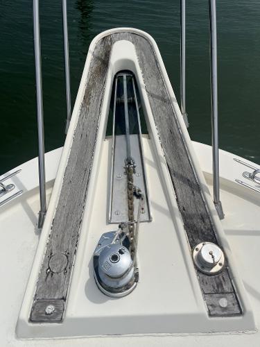 Bow of 1985 Hatteras 45 Convertible yacht with anchor chain and winch.