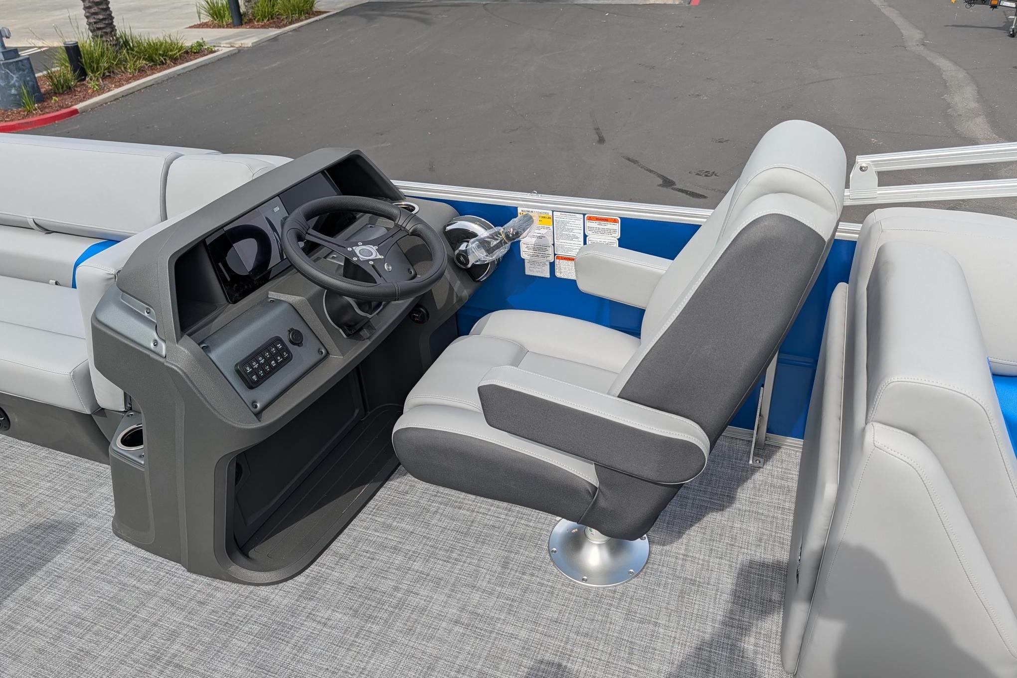 2026 Sun Tracker Party Barge 22 DLX interior with steering console and seating.