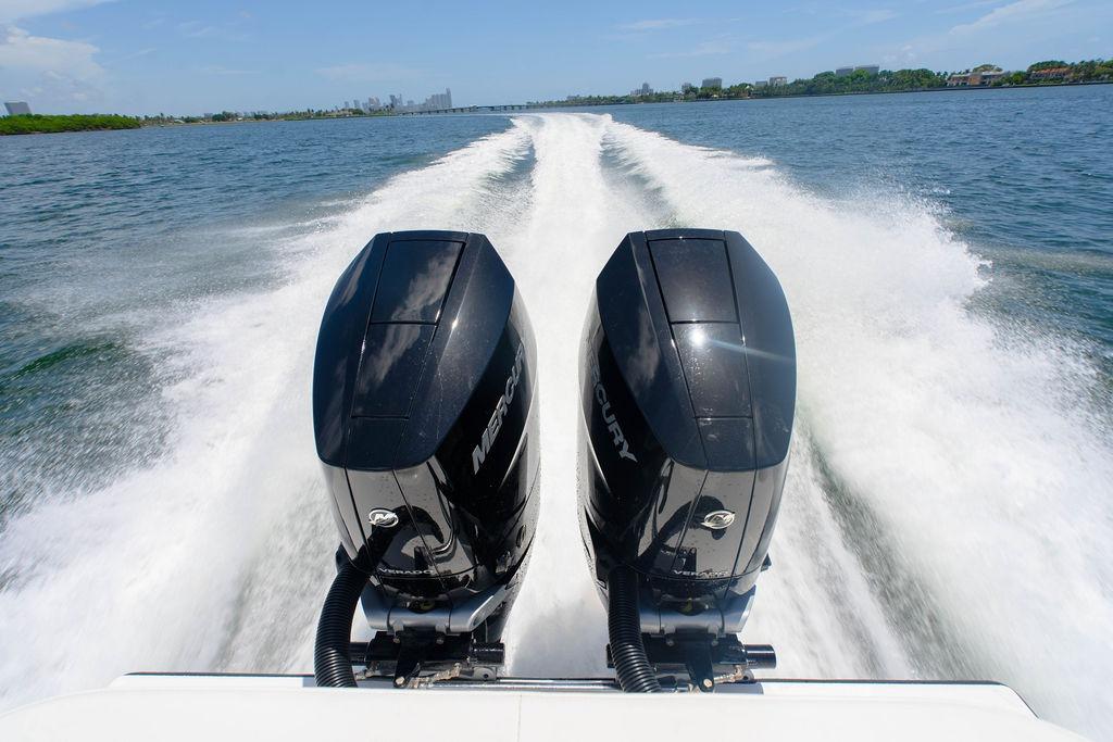 Reef Runner 340 boat with dual Mercury engines speeding on open water, 2027 model.