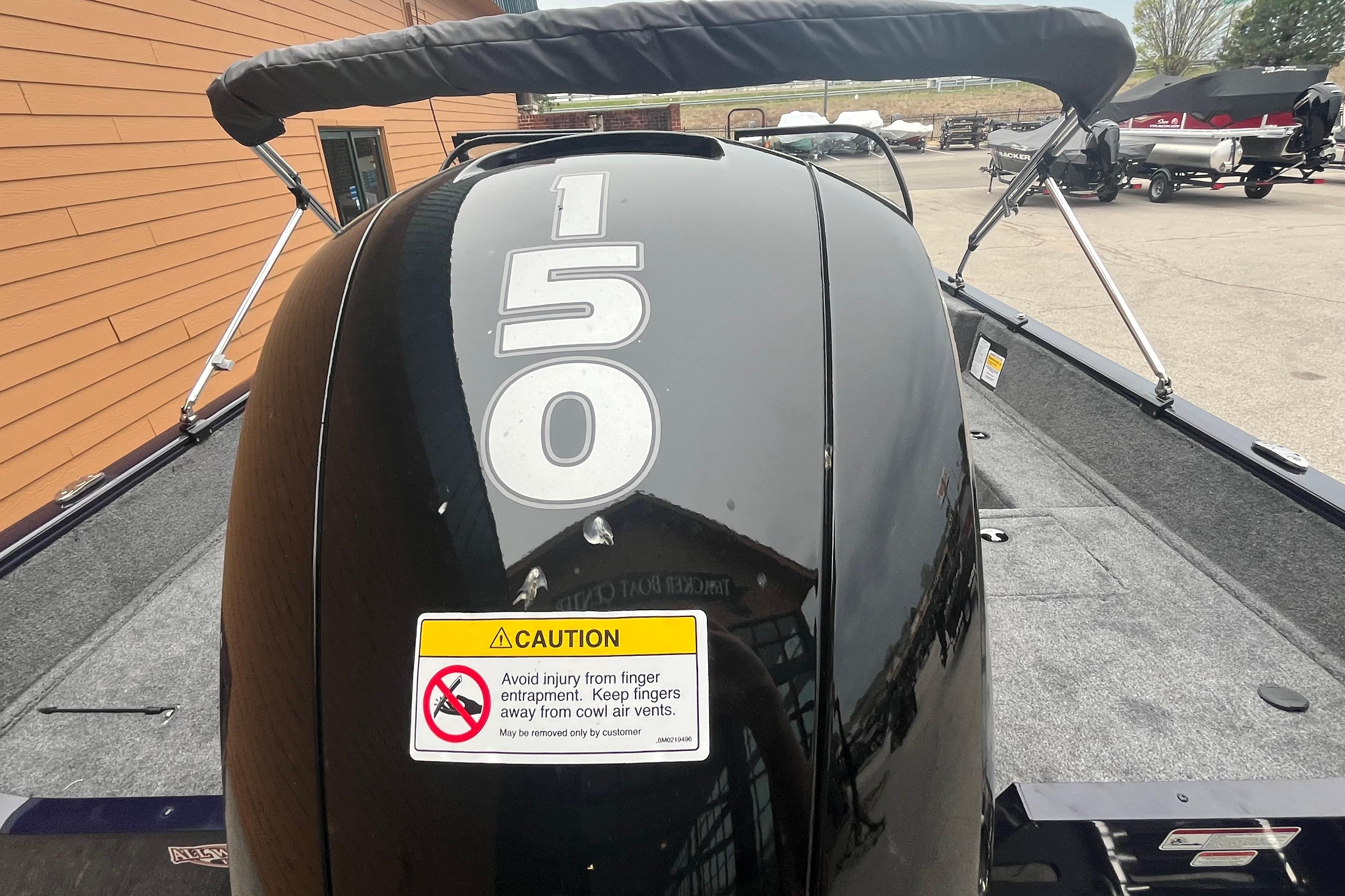 2026 Tracker Pro Guide V-175 WT boat with 150 HP engine, caution label visible.