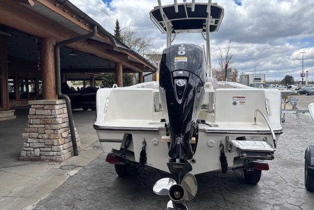 2026 Mako 214 Center Console boat with powerful outboard motor, parked outdoors.