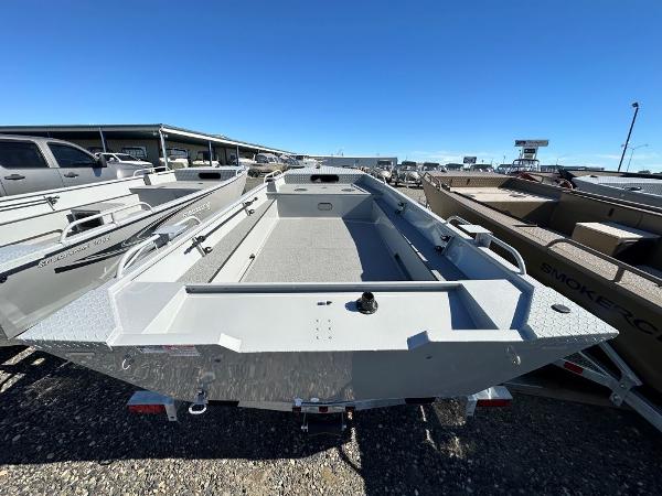 2024 Smoker Craft 1660 Sportsman aluminum fishing boat in a dealership lot.