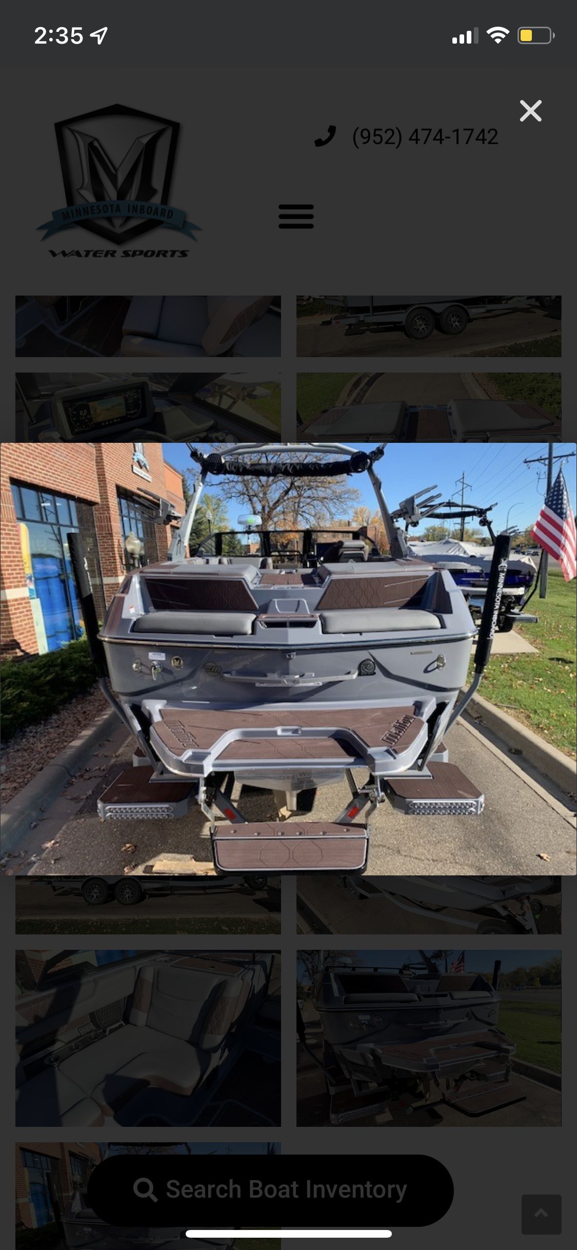 The image shows the rear of a 2022 Malibu M220 boat parked on a trailer.