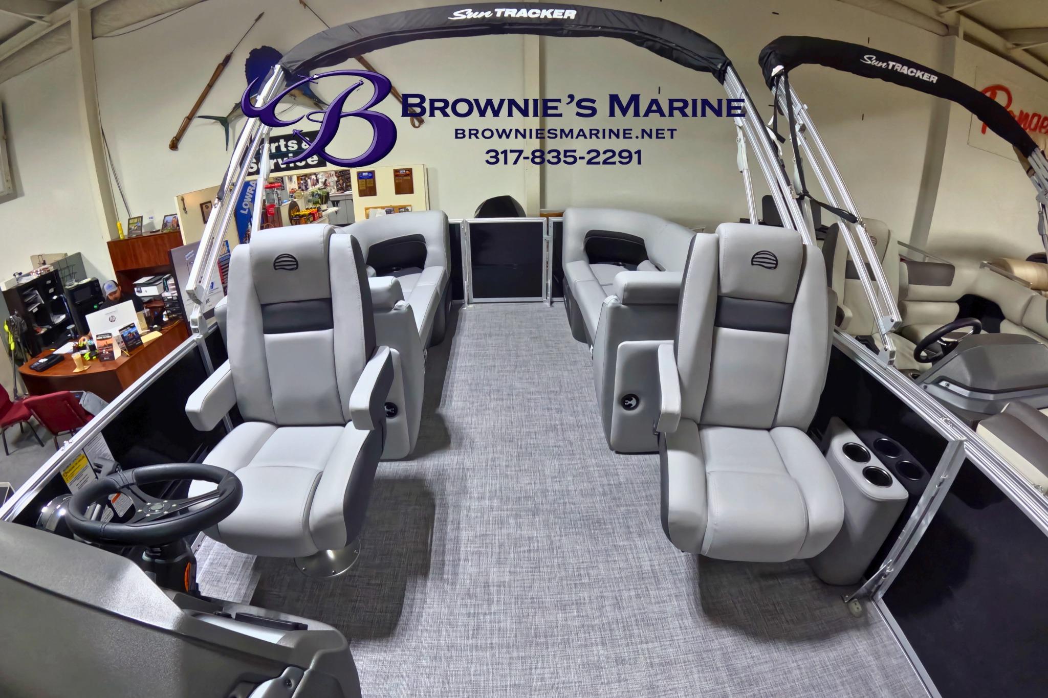 2026 Sun Tracker Party Barge 24 XP3 interior with plush seating at Brownie's Marine showroom.