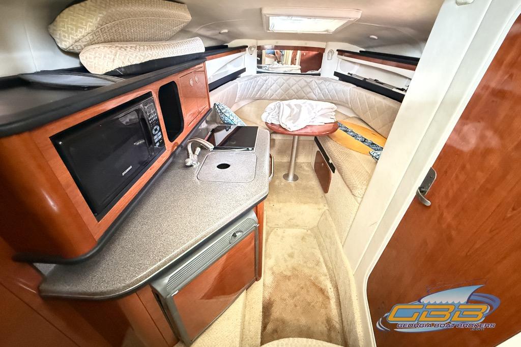 Interior of 2006 Sea Ray Sundancer 260 with kitchenette and cozy seating area.