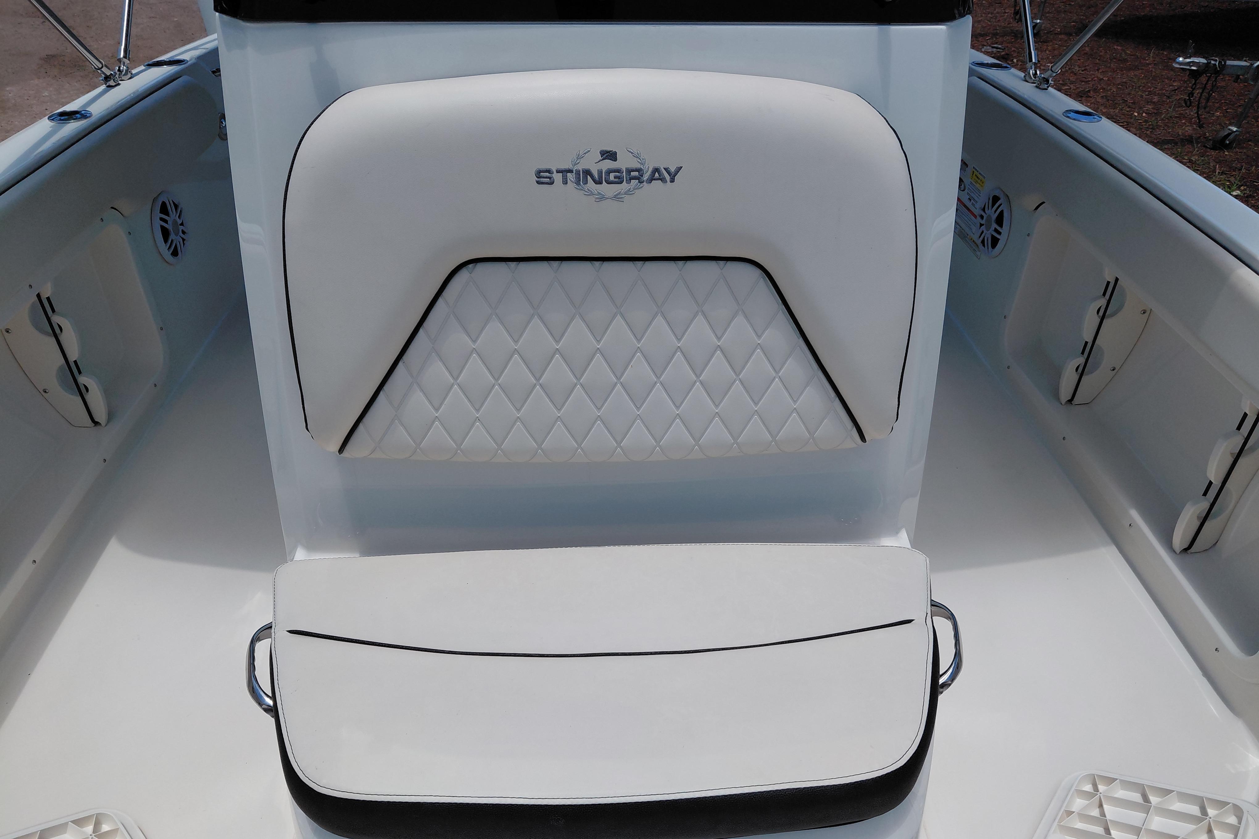 2023 Stingray 206 CC boat interior with white cushioned seating and diamond pattern design.