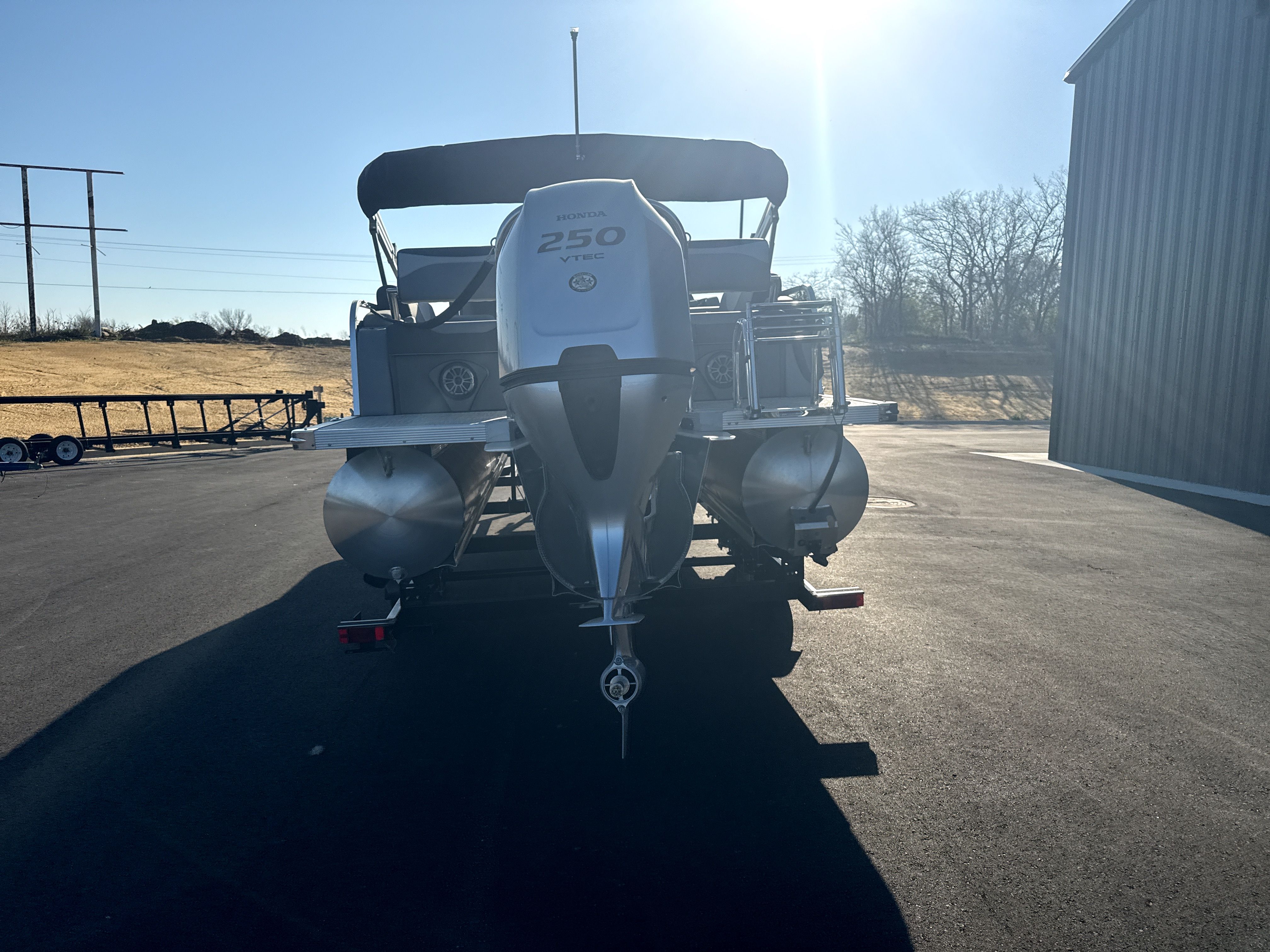 Rear view of 2026 Tahoe LTZ Quad Lounge Shift boat with Honda 250 VTEC engine.