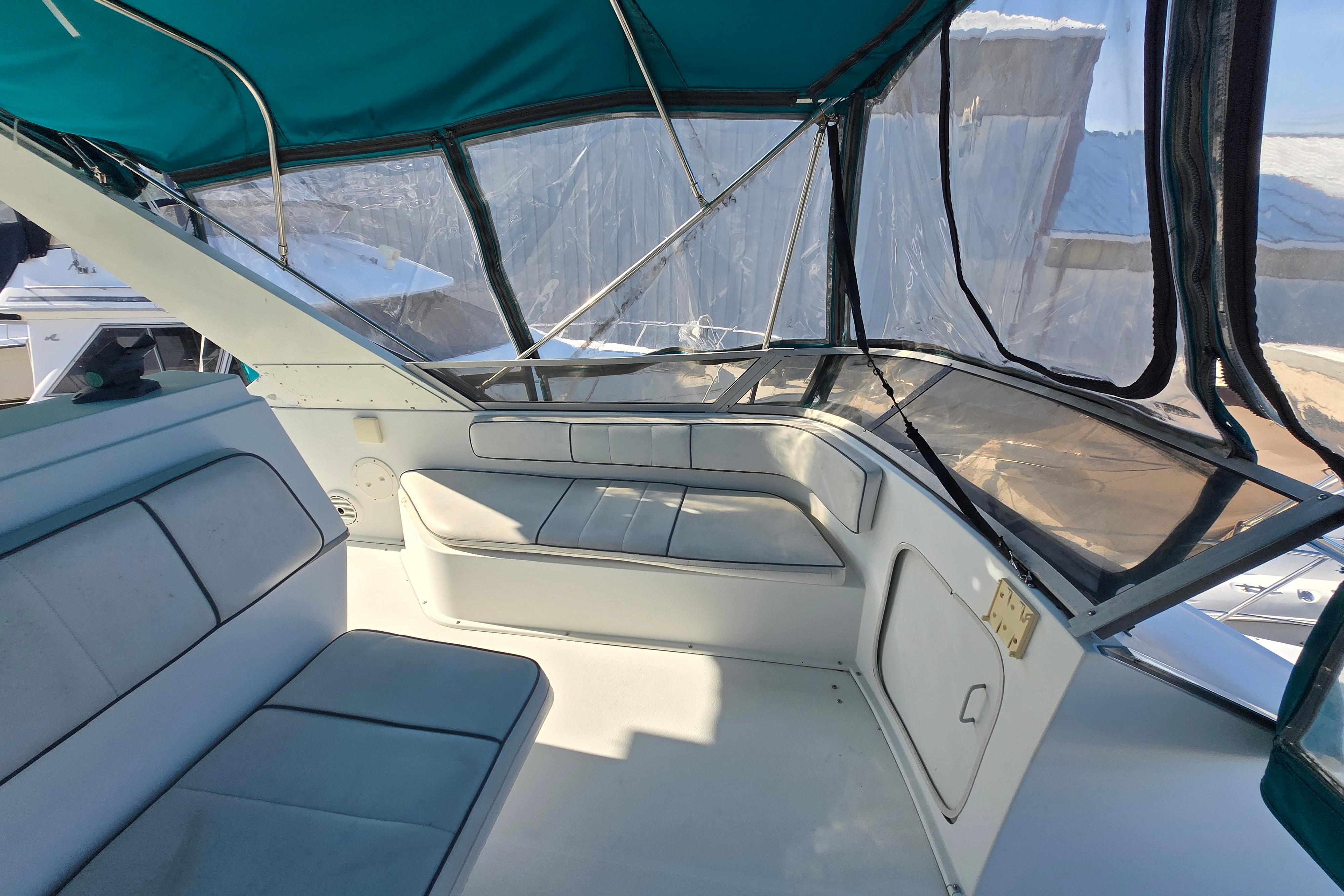 1994 Carver 380 Santego boat interior with teal canopy and cushioned seating.
