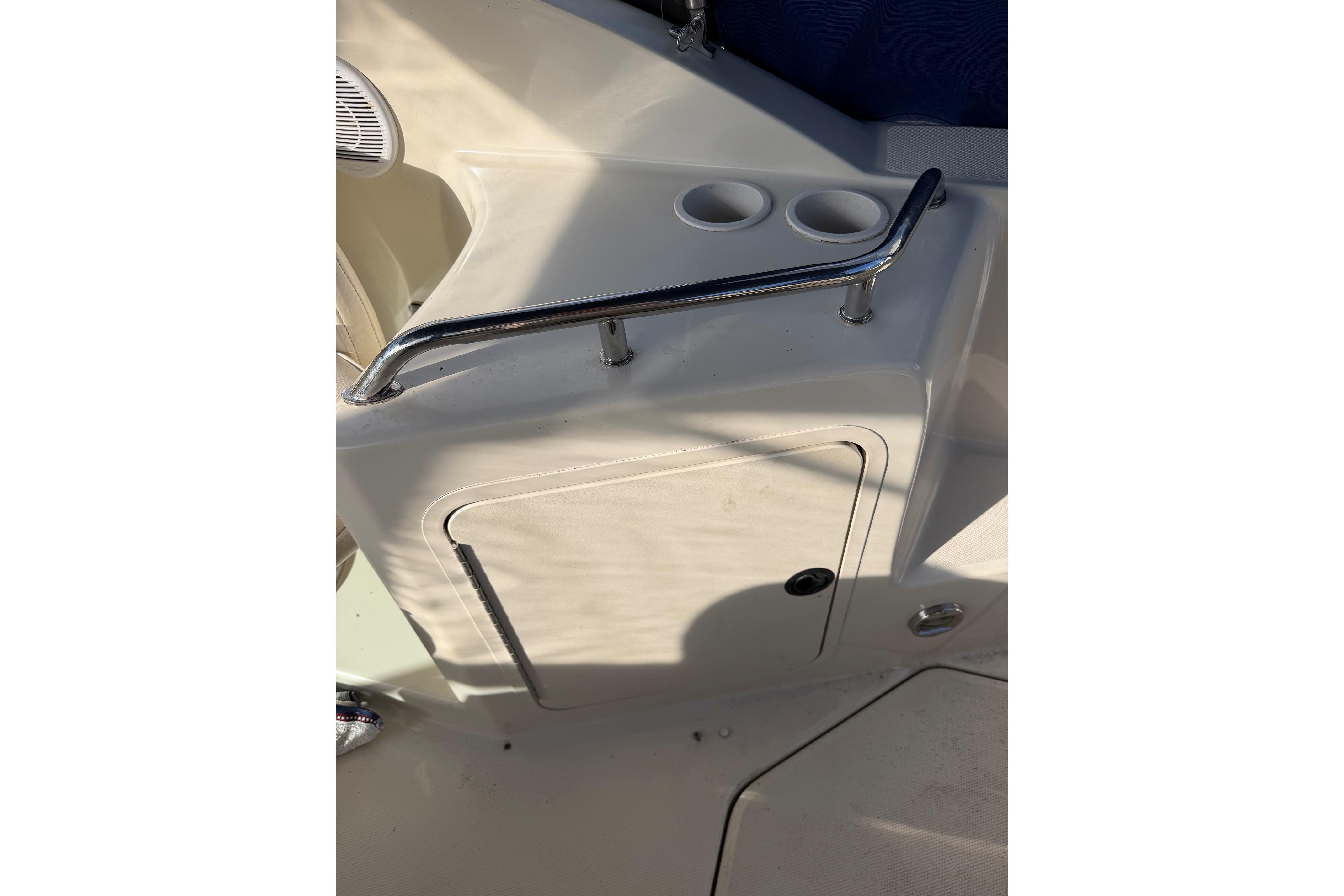 2000 Sea Ray 240 Sundancer boat interior with cup holders and storage compartment.