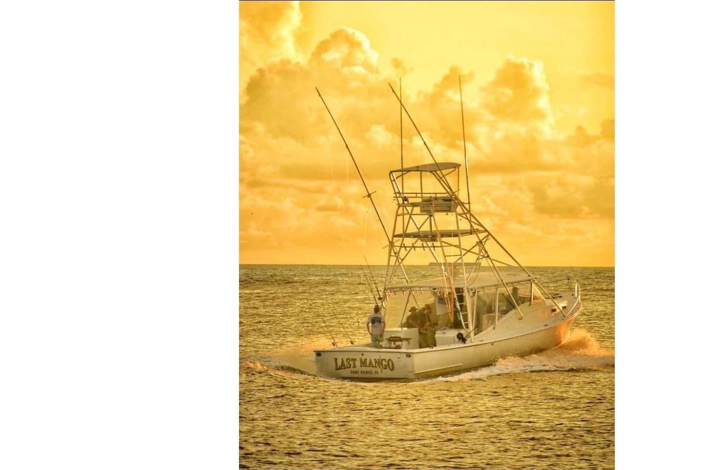 1987 Young Brothers sport fishing boat at sunset on the ocean.