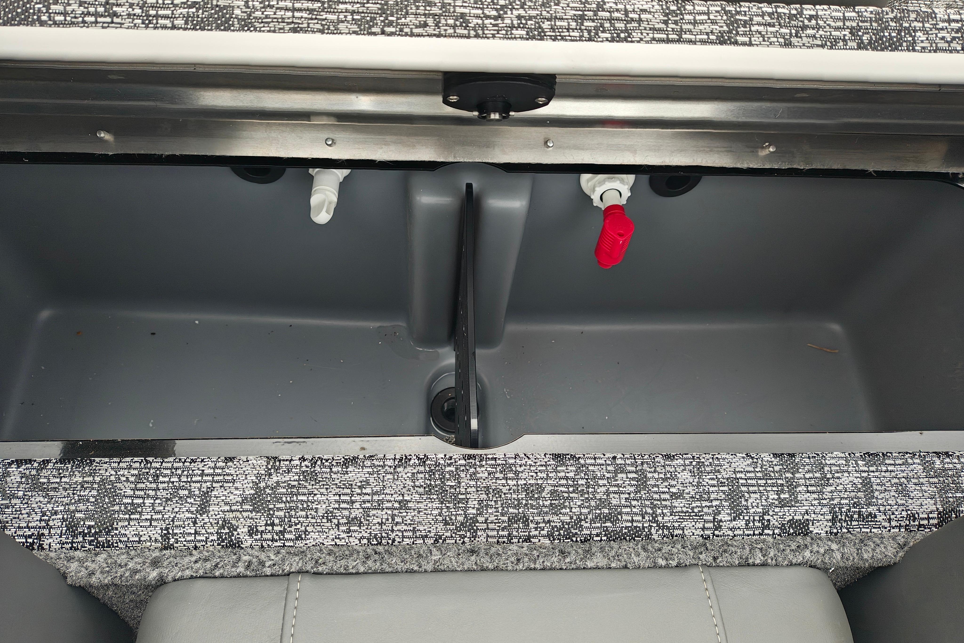 Livewell compartment in a 2026 Tracker Pro Team 175 boat, featuring plumbing and storage space.