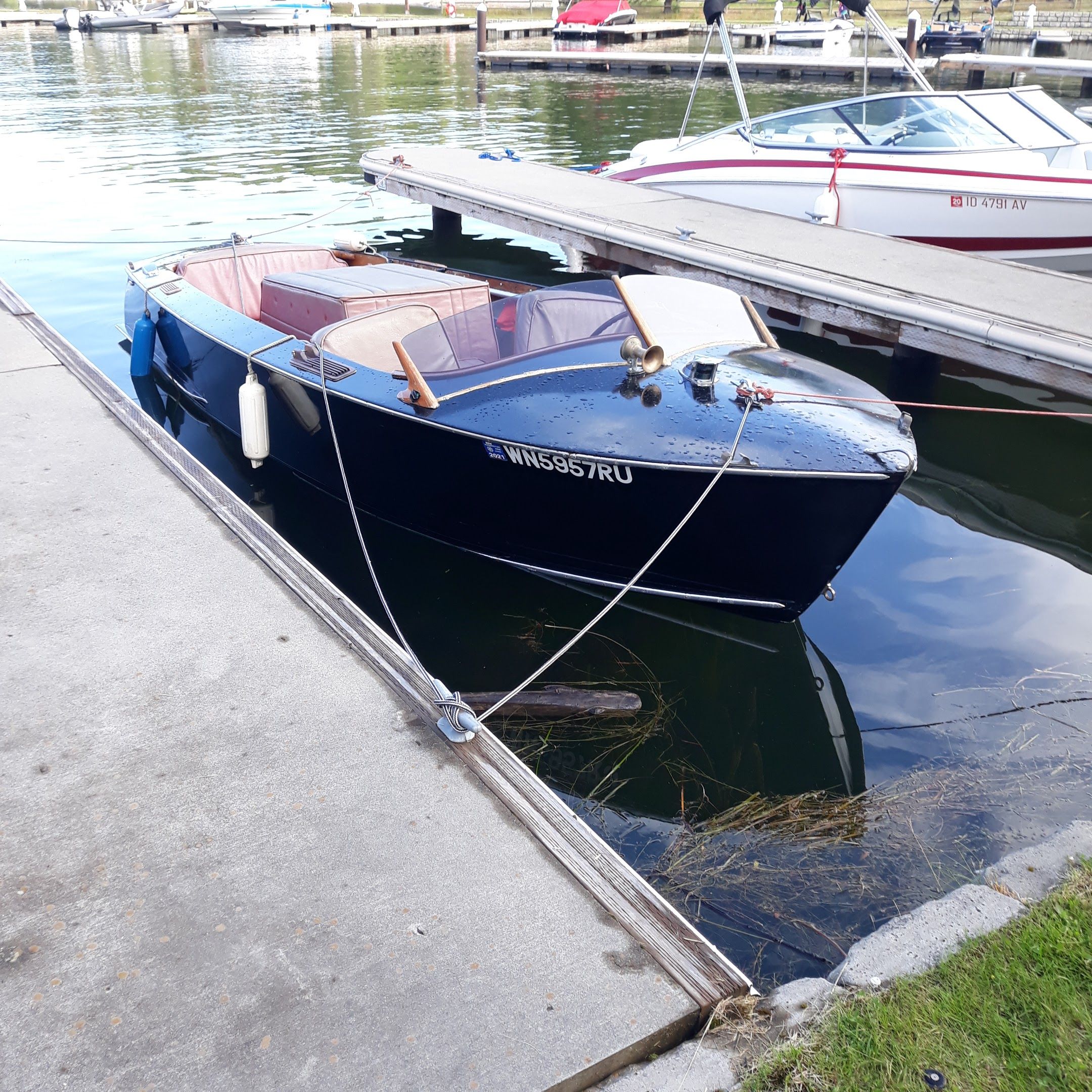 1948 Higgins 17.5 ft Runabout boat docked.