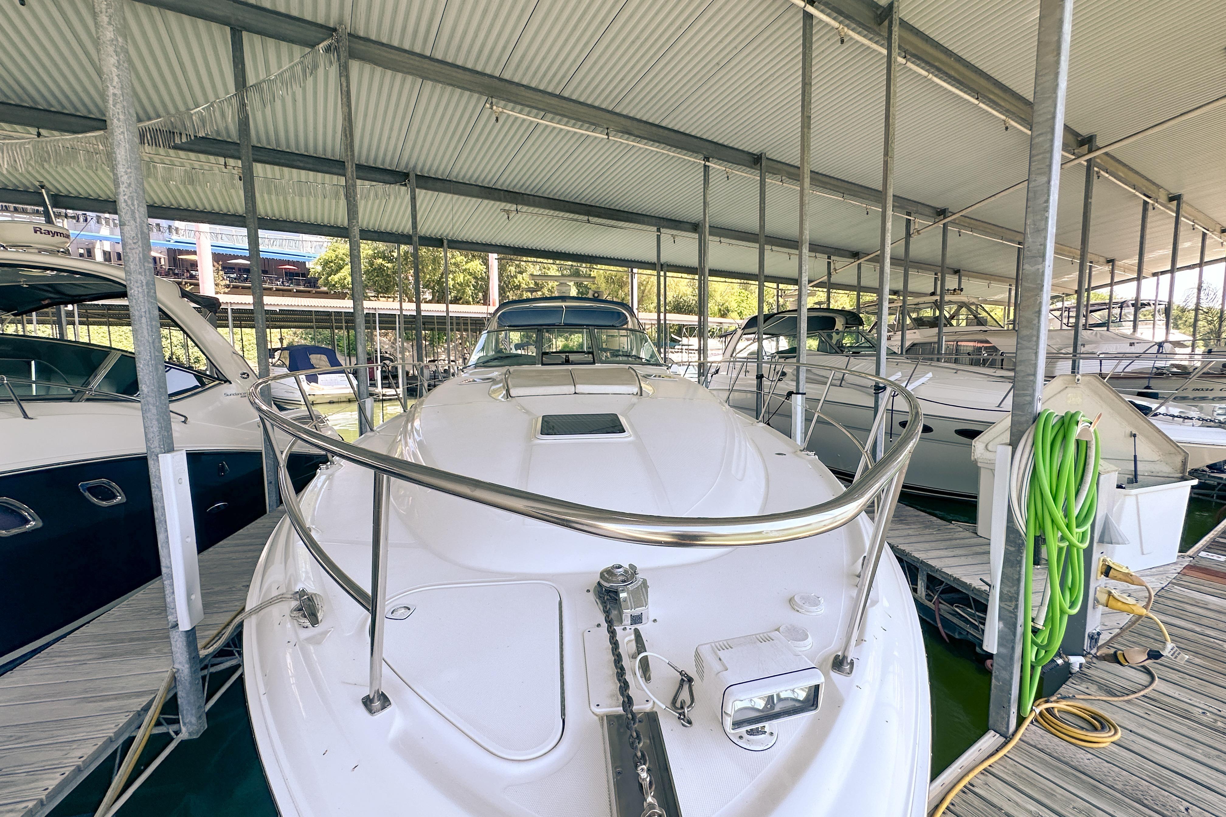 2001 Sea Ray 410 Sundancer yacht docked in a covered marina.