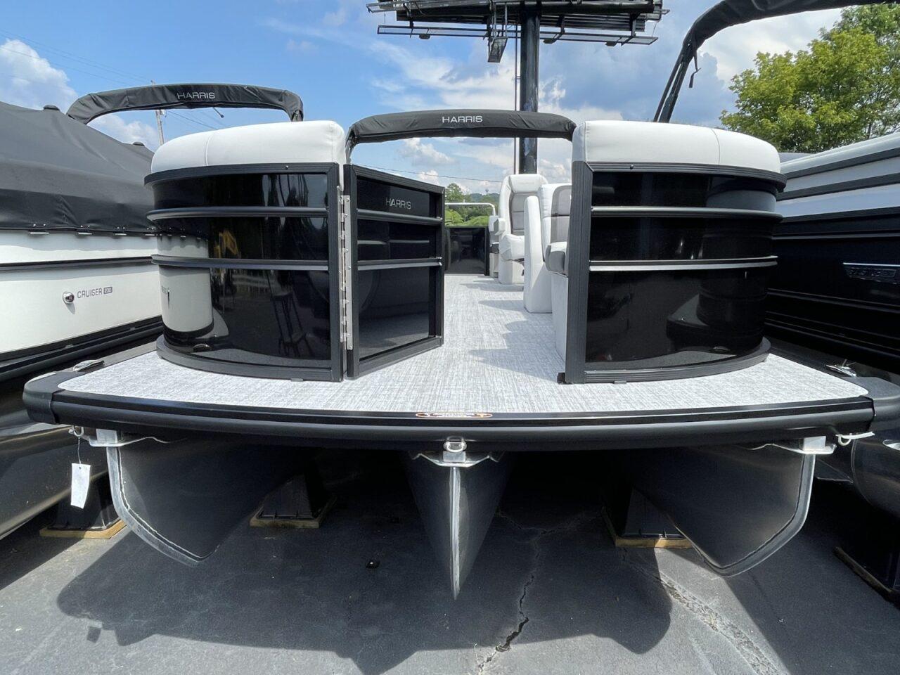 2026 Harris Cruiser 230 pontoon boat with sleek black design and spacious deck.