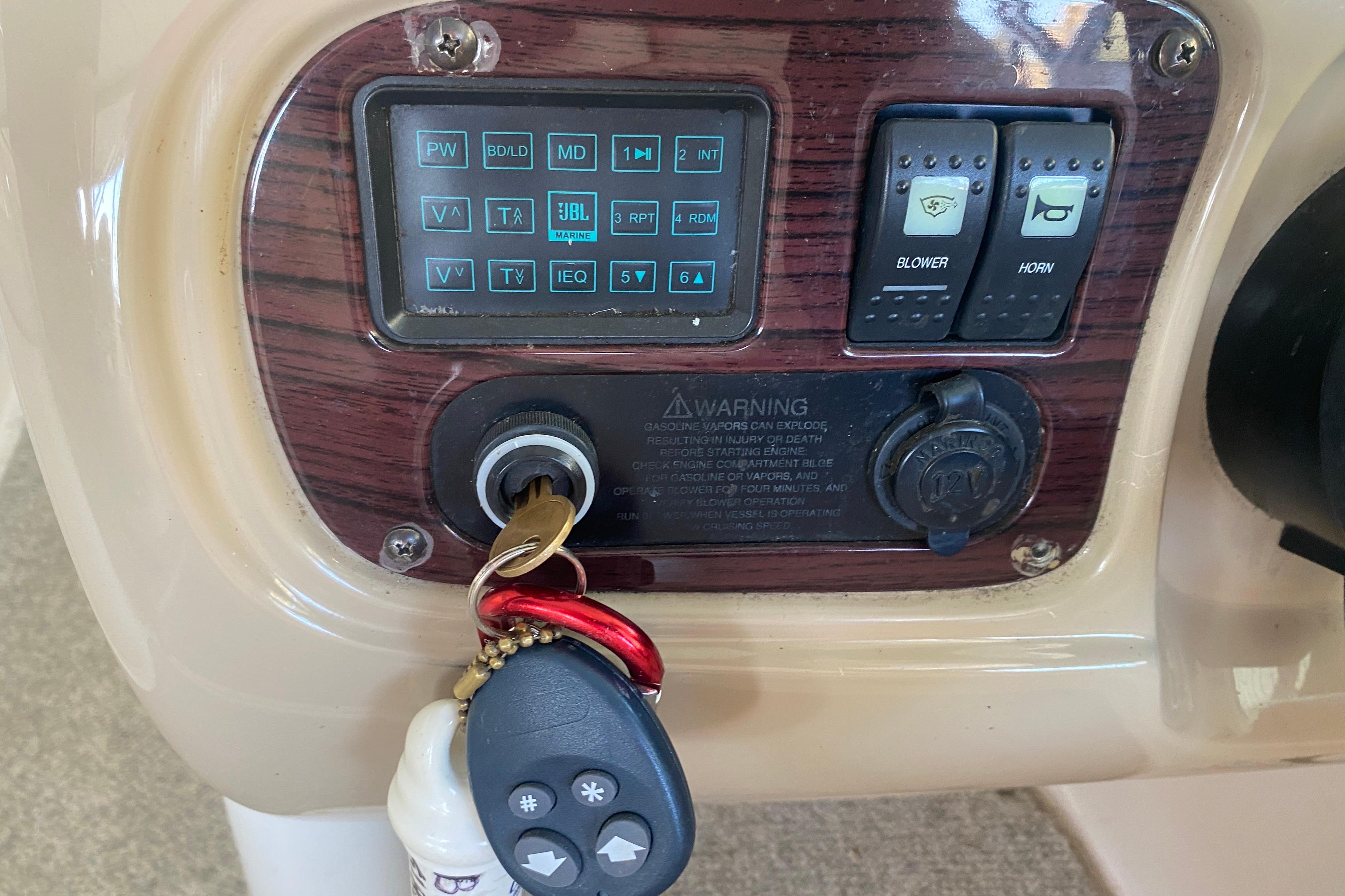 Control panel of a 2003 Chaparral Sunesta 263 boat with ignition and switches.