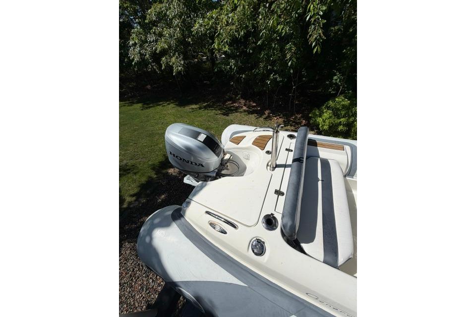 2016 Walker Bay Generation 450 DLX boat with Honda outboard motor, parked outdoors.