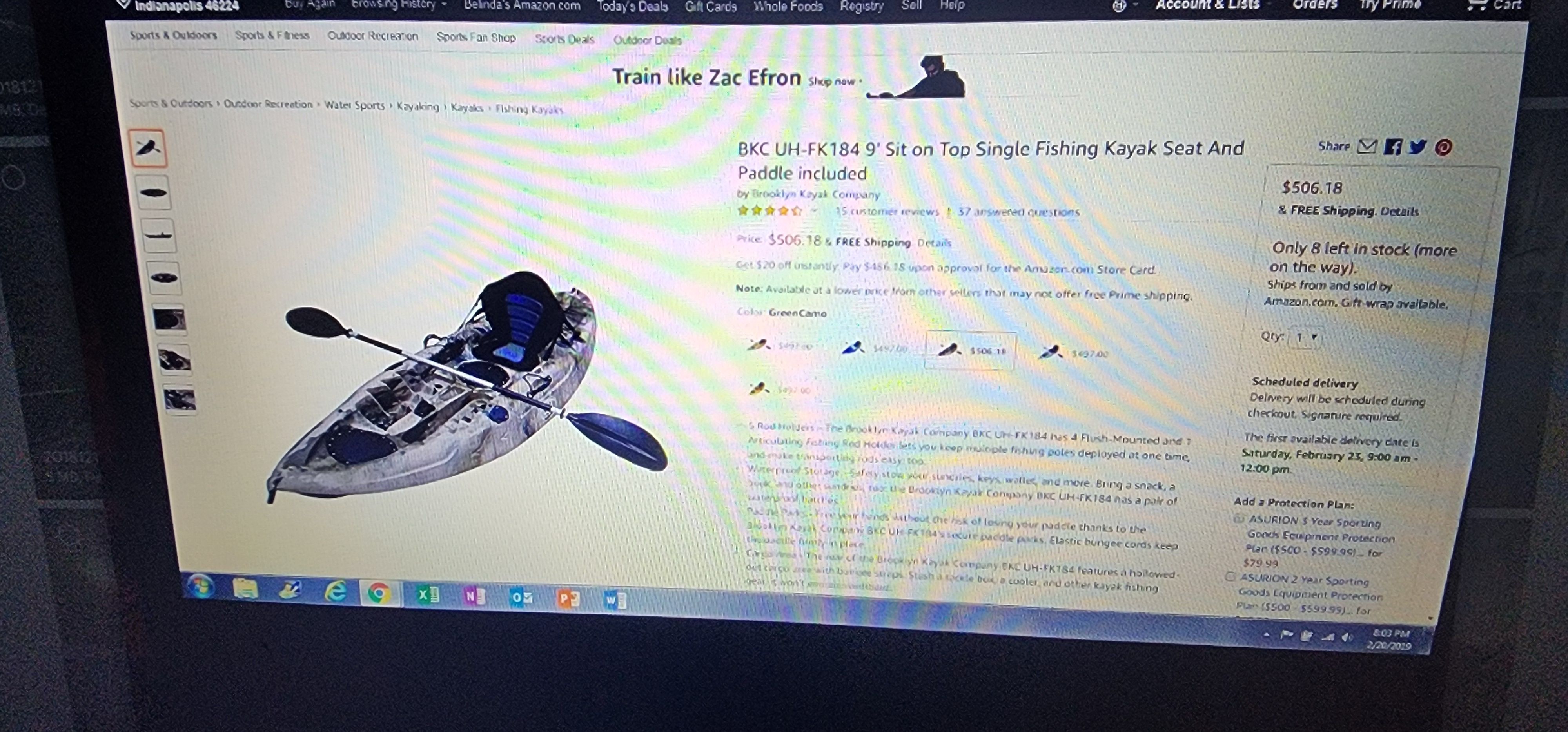 A laptop screen displays an online listing for a kayak with paddle.