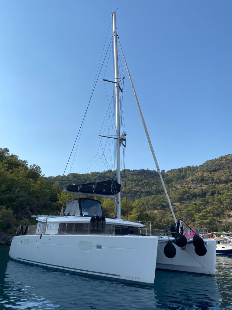 2018 Lagoon 450 catamaran anchored in scenic coastal waters.