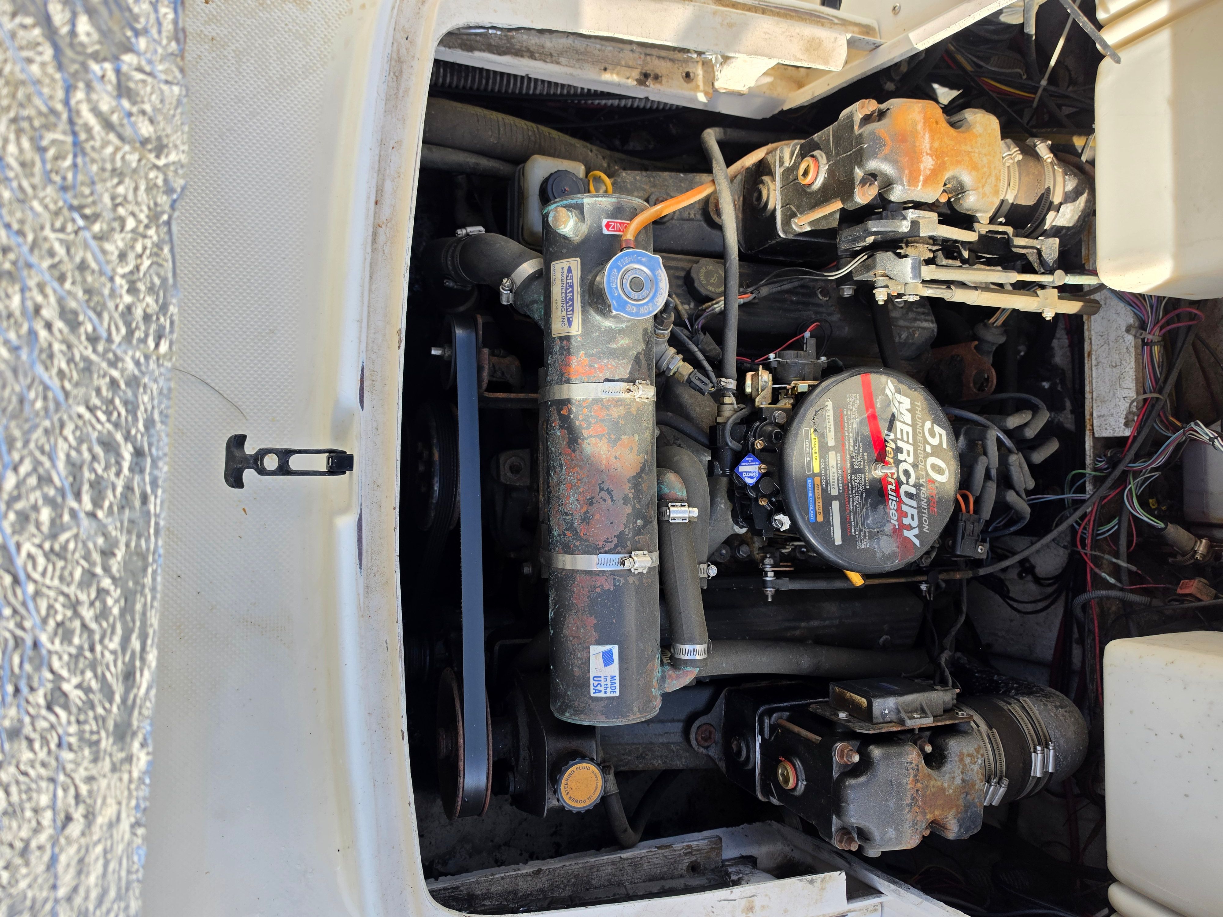 The engine compartment of a 2001 Bayliner 2352 Trophy Walkaround features a Mercury 5.0 engine.