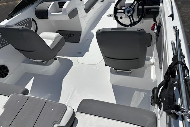 Interior of 2026 Tahoe T21 boat with gray seating and steering wheel.